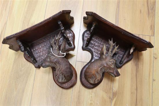 A pair of Black Forest walnut deers head wall brackets, late 19th century, height 24cm